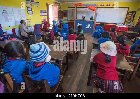 A small peruvian classroom in a primary school in an Andean Quechua community in the Cordillera Vilcanota. The kids watch a educational puppet show. Stock Photo