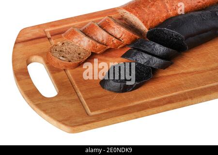 Sliced black and white bread baguettes on a wooden cutting board Stock Photo
