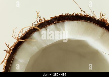 Coconut broken in two parts isolated shot in studio on white background. Stock Photo