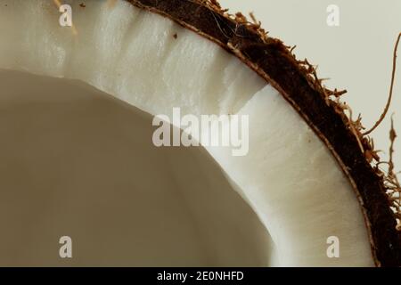 Coconut broken in two parts isolated shot in studio on white background. Stock Photo