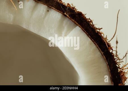 Coconut broken in two parts isolated shot in studio on white background. Stock Photo