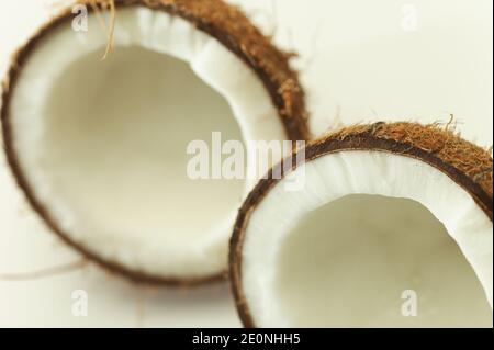 Coconut broken in two parts isolated shot in studio on white background. Stock Photo