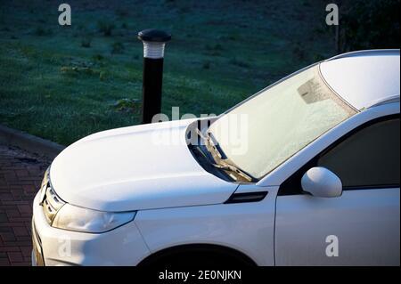 Ice on frozen car window during winter early morning Stock Photo
