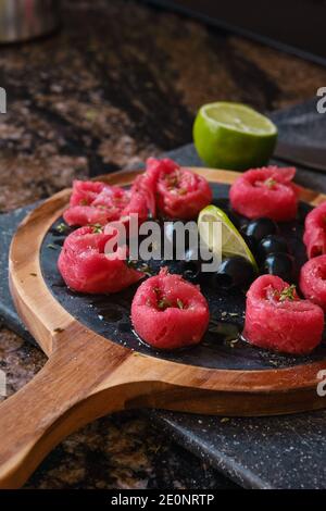 meat carpaccio with olives and lime Stock Photo