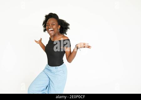 Afro-American young woman yelling with afraid of something, isolated on white Stock Photo