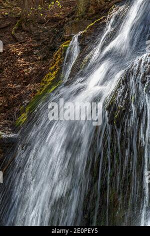 Waterfall running on a rock wall Stock Photo