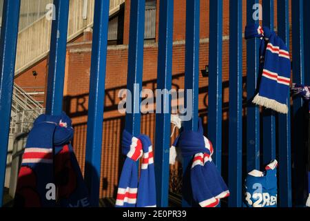 Glasgow, UK, 2 January 2021. Supporters of Rangers Football Club tie scarves on the club's stadium gate, in memory of those 66 fans who lost their life in the Ibrox Stadium disaster which happened 50-years ago today on 2nd January 1971. The anniversary falls on the day that Rangers FC plays their rivals Celtic FC, at home, in a League game. Photo: JeremyS utton-Hibbert/Alamy Live News. Stock Photo