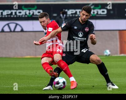 Heidenheim, Germany. 02nd Jan, 2021. Soccer: 2. Bundesliga, 1. FC Heidenheim - 1. FC Nürnberg, Matchday 14 at Voith-Arena. Heidenheim's Christian Kühlwetter (l) and Nürnberg's Lukas Mühl fight for the ball. Credit: Stefan Puchner/dpa - IMPORTANT NOTE: In accordance with the regulations of the DFL Deutsche Fußball Liga and/or the DFB Deutscher Fußball-Bund, it is prohibited to use or have used photographs taken in the stadium and/or of the match in the form of sequence pictures and/or video-like photo series./dpa/Alamy Live News Stock Photo