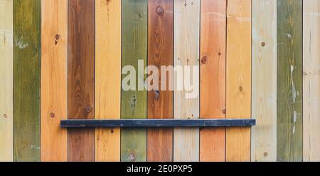 Wooden background from multi-colored boards. Wall or fence, vintage. Stock Photo