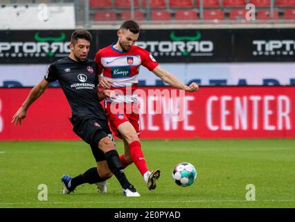 Heidenheim, Germany. 02nd Jan, 2021. Football: 2nd Bundesliga, 1. FC Heidenheim - 1. FC Nürnberg, Matchday 14 at Voith Arena. Heidenheim's Denis Thomalla (r) and Nürnberg's Lukas Mühl fight for the ball. Credit: Stefan Puchner/dpa - IMPORTANT NOTE: In accordance with the regulations of the DFL Deutsche Fußball Liga and/or the DFB Deutscher Fußball-Bund, it is prohibited to use or have used photographs taken in the stadium and/or of the match in the form of sequence pictures and/or video-like photo series./dpa/Alamy Live News Stock Photo