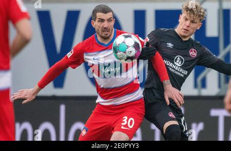 Heidenheim, Germany. 02nd Jan, 2021. Soccer: 2. Bundesliga, 1. FC Heidenheim - 1. FC Nürnberg, Matchday 14 at Voith-Arena. Heidenheim's Norman Theuerkauf (l) and Nürnberg's Robin Hack fight for the ball. Credit: Stefan Puchner/dpa - IMPORTANT NOTE: In accordance with the regulations of the DFL Deutsche Fußball Liga and/or the DFB Deutscher Fußball-Bund, it is prohibited to use or have used photographs taken in the stadium and/or of the match in the form of sequence pictures and/or video-like photo series./dpa/Alamy Live News Stock Photo