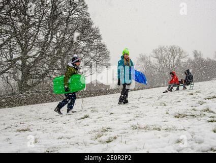 Downham, Clitheroe, Lancashire, UK. 2nd Jan, 2021. A snow storm on Pendle Hill near Downham, Clitheroe, Lancashire surprised people sledging and walkers . Credit: John Eveson/Alamy Live News Stock Photo