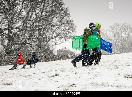 Downham, Clitheroe, Lancashire, UK. 2nd Jan, 2021. A snow storm on Pendle Hill near Downham, Clitheroe, Lancashire surprised people sledging and walkers . Credit: John Eveson/Alamy Live News Stock Photo