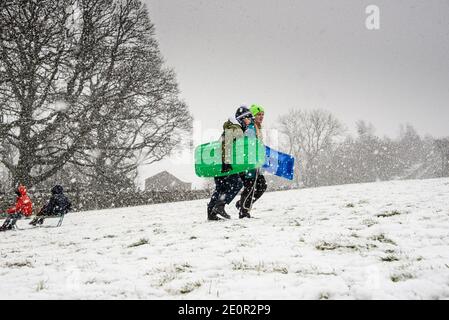 Downham, Clitheroe, Lancashire, UK. 2nd Jan, 2021. A snow storm on Pendle Hill near Downham, Clitheroe, Lancashire surprised people sledging and walkers . Credit: John Eveson/Alamy Live News Stock Photo