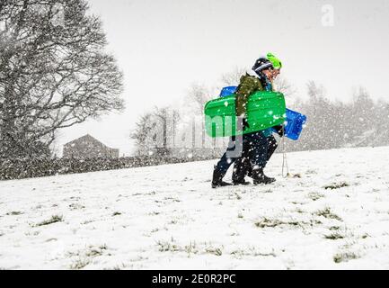 Downham, Clitheroe, Lancashire, UK. 2nd Jan, 2021. A snow storm on Pendle Hill near Downham, Clitheroe, Lancashire surprised people sledging and walkers . Credit: John Eveson/Alamy Live News Stock Photo