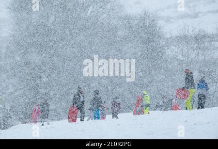 Downham, Clitheroe, Lancashire, UK. 2nd Jan, 2021. A snow storm on Pendle Hill near Downham, Clitheroe, Lancashire surprised people sledging and walkers . Credit: John Eveson/Alamy Live News Stock Photo