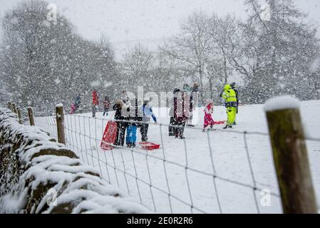 Downham, Clitheroe, Lancashire, UK. 2nd Jan, 2021. A snow storm on Pendle Hill near Downham, Clitheroe, Lancashire surprised people sledging and walkers . Credit: John Eveson/Alamy Live News Stock Photo