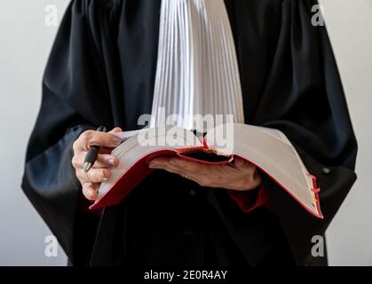 lawyer woman holding red law book - French Young beautiful woman lawyer Stock Photo