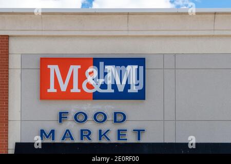 Sign on the facade of an M&M Food Market. The image is a close up with no people on it