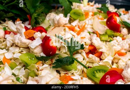 Sliced cauliflower, red peppers and green tomatoes prepared for pickling Stock Photo