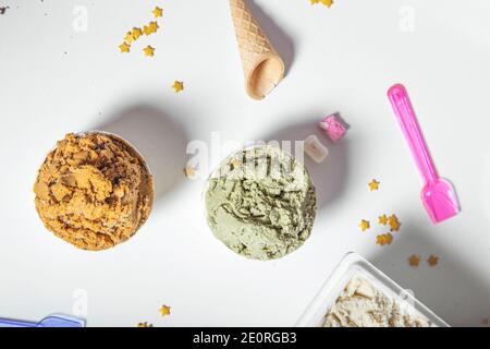 Top view of tubs of artisan ice cream of various flavors on a white background Stock Photo