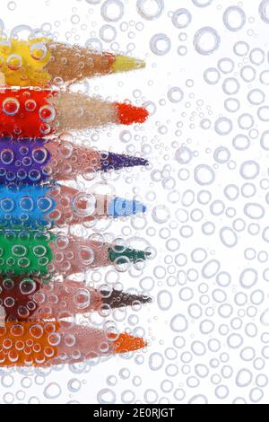 Colored pencils in air bubbles Stock Photo