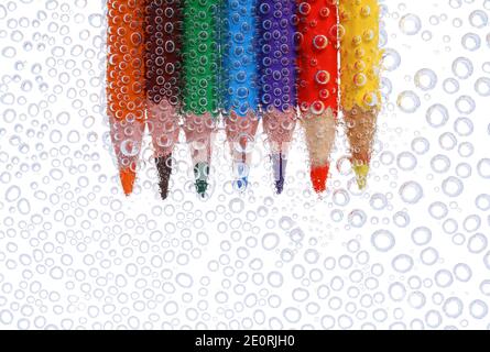 Colored pencils in air bubbles Stock Photo