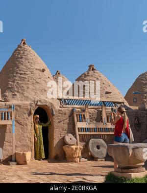 Sanli Urfa, Turkey- September 12 2020: Tourists posing in local clothes in front of harran houses. Stock Photo