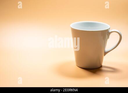 Close up white mug on empty space area, copy space area yellow background Stock Photo