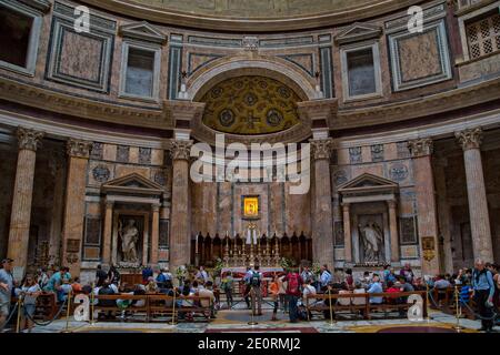 Tourists inside the Pantheon in Rome. The Pantheon is a ancient Roman temple converted into a church built by Emperor Hadrian, Rome, Italy Stock Photo