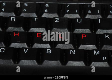 help in red writing on a computer keyboard Stock Photo