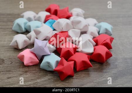 Variety of colored origami paper stars pile Stock Photo