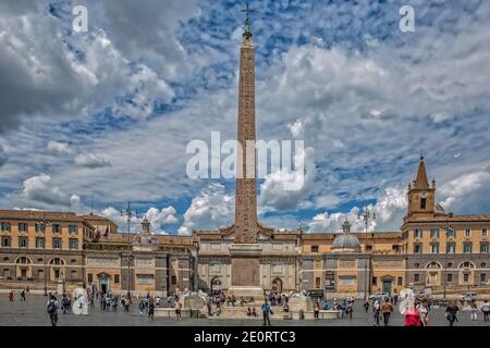 Tourists visit the Piazza Popolo in historic center of Rome.Marble lions and fountains surround an old obelisk in center of Piazza Popolo, Rome, Italy Stock Photo