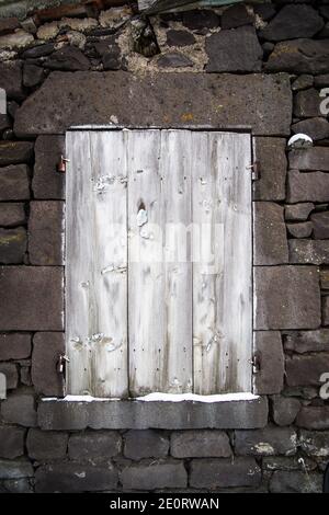 Boarded up window in an abandoned village house in (Auvergne), France Stock Photo
