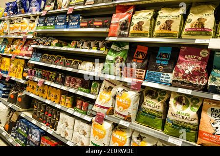 London UK, January 02 2021, Selection Of Tinned Dog Food And Dry Biscuits On Supermarket Shelves Stock Photo