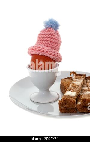 A boiled egg with toasted and buttered bread slices stock photo Stock Photo