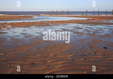 Wave and tidal patterns in the sand on the beach at low water on the North Norfolk coast at Happisburgh, Norfolk, England, United Kingdom. Stock Photo