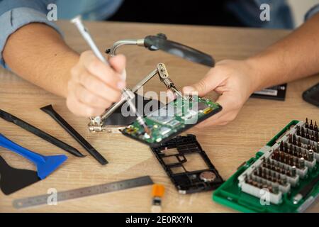 computer technician installs cooling system of computer Stock Photo