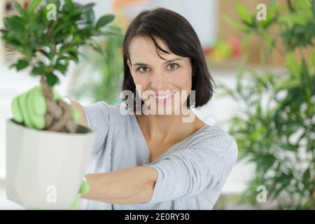 young woman looking after plants at home Stock Photo