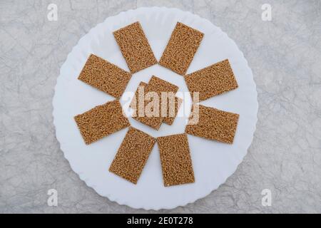 Til sakri or Tilgul an Indian traditional popular sweet made out of Sesame seeds and jaggery melted and set in to sheets and cut. Famous Sankranti fes Stock Photo