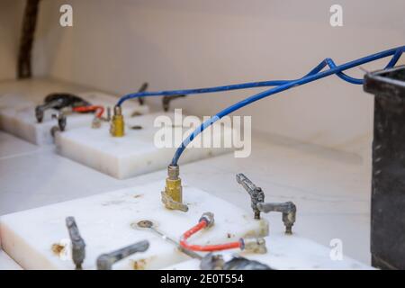 Workers lifting and gluing with new maple granite counter in kitchen cabinets Stock Photo