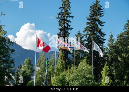 Whistler, Canada - July 5,2020: View of poles with waving flags in the Whistler Village