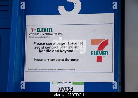 Vancouver, Canada - July 13,2020: Covid-19 update sign at  Esso Gas Station. Please avoid contact with pump handle and keypad. Stock Photo