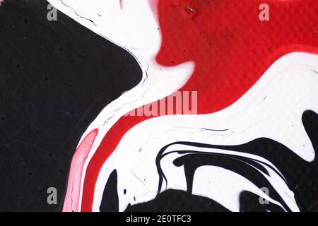 Marbled acrylic colored pattern in the colors red, black, white and pink Stock Photo