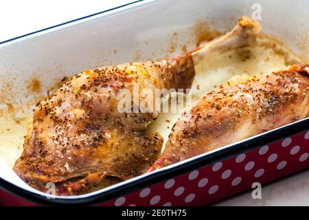 baked goose legs with cumin in frying pan Stock Photo