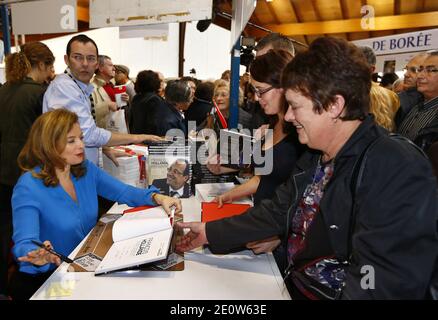 Valerie Trierweiler presente son livre en compagnie du photographe Stephane Ruet durant le 31° Salon du Livre de Brive en Correze le 10 Novembre 2012. Valerie Trierweiler a profité de la ville en se promenant et en visitant le marche. Ils posent sur leur stand avec Erik Orsenna president du Salon litteraire. Photo by Patrick Bernard/ABACAPRESS.COM Stock Photo