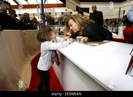 Valerie Trierweiler presente son livre en compagnie du photographe Stephane Ruet durant le 31° Salon du Livre de Brive en Correze le 10 Novembre 2012. Valerie Trierweiler a profité de la ville en se promenant et en visitant le marche. Ils posent sur leur stand avec Erik Orsenna president du Salon litteraire. Photo by Patrick Bernard/ABACAPRESS.COM Stock Photo