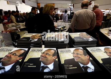 Valerie Trierweiler presente son livre en compagnie du photographe Stephane Ruet durant le 31° Salon du Livre de Brive en Correze le 10 Novembre 2012. Valerie Trierweiler a profité de la ville en se promenant et en visitant le marche. Ils posent sur leur stand avec Erik Orsenna president du Salon litteraire. Photo by Patrick Bernard/ABACAPRESS.COM Stock Photo