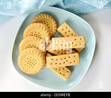 Scottish shortbread cookies on pale blue plate in horizontal format shot from overhead. Stock Photo