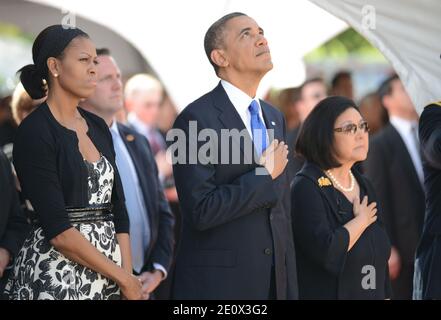 President Barack Obama and First Lady Michelle Obama look up as Hawaii Air National Guard F-22 Raptors make a flyby standing with right, Senator Daniel Inouye's wife Irene Hirano fronting the casket of the late Senator Daniel Inouye at the National Memorial Cemetery of the Pacific during funeral services. Senator Inouye was a Medal of Honor recipient and a United States Senator since 1963 In Hawai on December 23, 2012. Photo Cory Lum/ABACAPRESS.COM Stock Photo